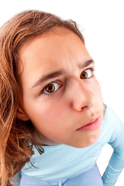 Cute teenager girl with funny face expression looking to camera, isolated. April fool day - 写真・画像