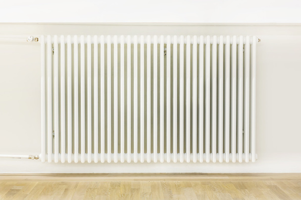 Heating system attached to a white wall - Zdjęcie, obraz