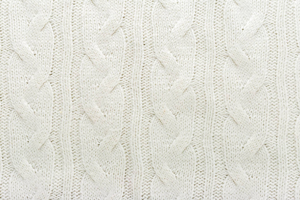 Beige knitted fabric wool texture for background. Close up of White Knitted material pattern for design. Beige warm sweater textile background. - Foto, afbeelding