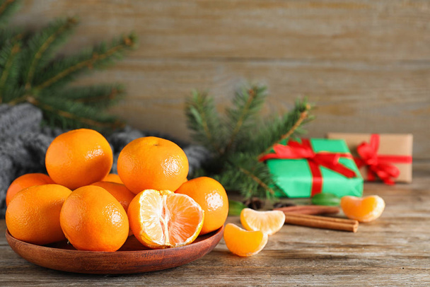 Tasty fresh tangerines on wooden table. Christmas celebration - Photo, image