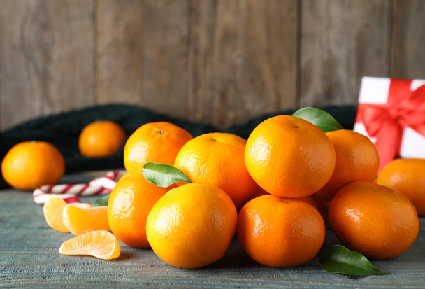 Tasty fresh tangerines on blue wooden table. Christmas celebration - Photo, image