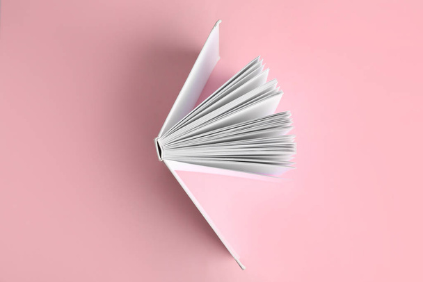 Hardcover book on pink background, top view - Zdjęcie, obraz