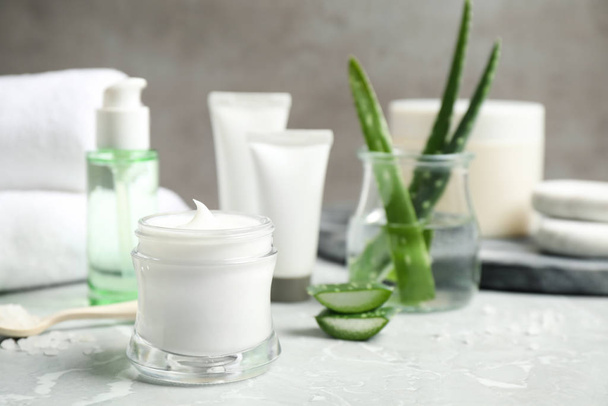 Open jar of aloe cream on grey marble table. Organic cosmetics - Foto, Imagen