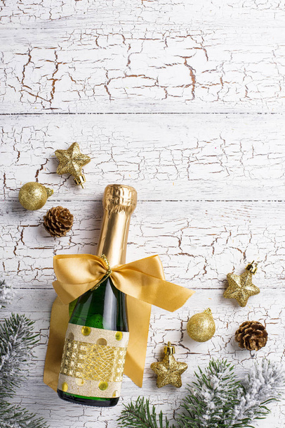 Bottle of champagne in a gold wrapper - Fotó, kép