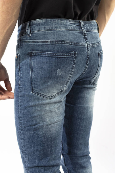man in jeans, denim pants close up on white background, blue jeans, blue t-shirt - Foto, imagen