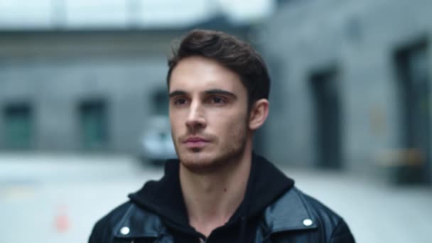 Closeup young man looking camera on urban background. Portrait of handsome man - Footage, Video