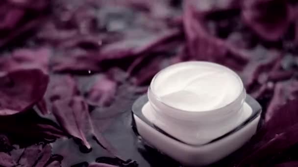 Sensitive skincare moisturizer face cream on flower petals and water background, natural science for skin - Footage, Video