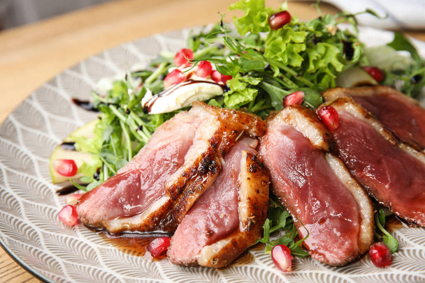 Delicious salad with roasted duck breast on plate, closeup - Foto, afbeelding