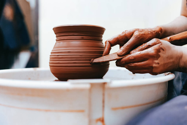 Girl works behind a pottery wheel forms a jug to perfect forms - Photo, Image
