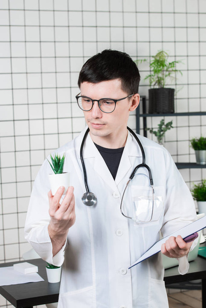 Scientist Conducts Experiments with a green Plant - Foto, imagen