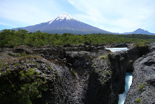 A view from the valley with basaltic lava rocks in Vicente Perez Rosales National Park, Chile. - Photo, Image