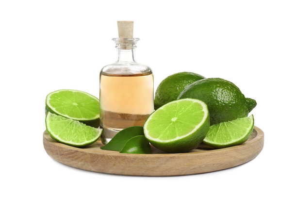 Lime essential oil in bottle and citrus fruits isolated on white - Φωτογραφία, εικόνα