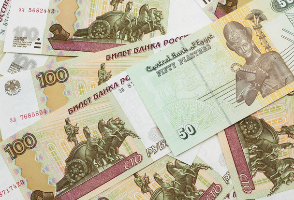 A close up image of an Egyptian fifty pisatres note with Russian one hundred ruble bills in macro - Photo, Image