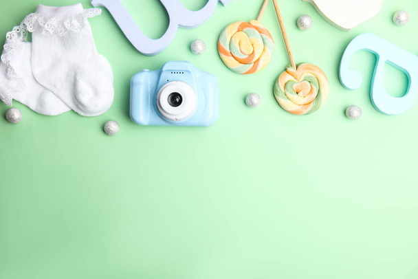 Flat lay composition with toy camera on light green background, space for text. Future photographer - Foto, Imagen