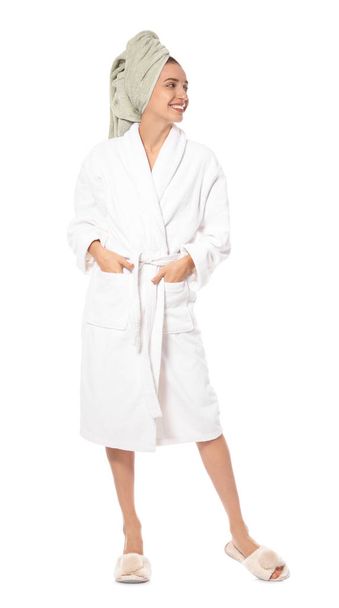 Beautiful young woman wearing bathrobe on white background - Foto, afbeelding