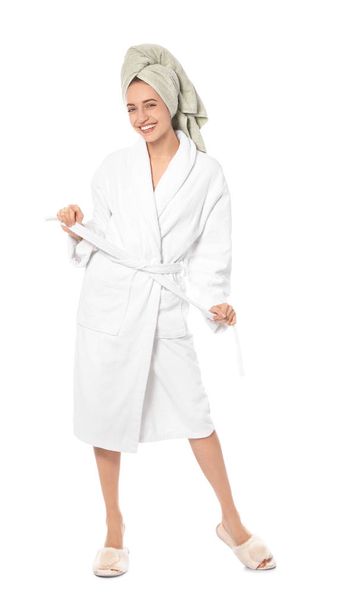 Beautiful young woman wearing bathrobe on white background - 写真・画像