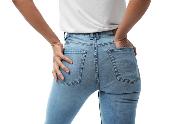 Woman wearing jeans on white background, closeup - Foto, afbeelding