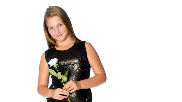 Teenage girl with a flower in her hand - Φωτογραφία, εικόνα
