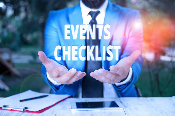 Text sign showing Events Checklist. Conceptual photo invaluable tool for successfully analysisaging your events Man with opened hands in fron of the table. Mobile phone and notes on the table. - Photo, Image