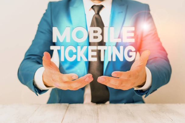 Conceptual hand writing showing Mobile Ticketing. Business photo showcasing tickets arrive as a text message with a special barcode Man holds empty paper with copy space in front of him Space. - Photo, Image