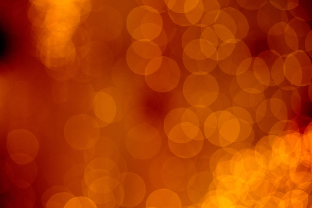 Golden holiday bokeh abstract texture. Colorful defocused background with blurred bright light glitter - 写真・画像