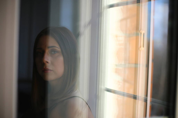 Pensive girl by the window - Photo, Image