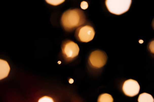 Golden abstract bokeh sparkle on black isolated background. Holiday concept. - Fotoğraf, Görsel