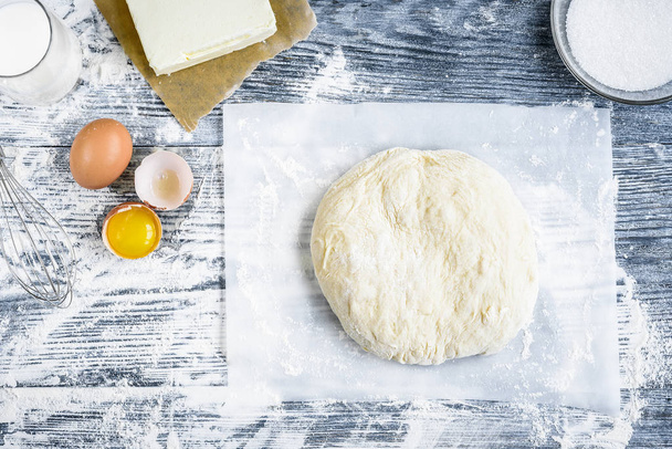 Dough mixing recipe bread, pizza or pie making ingridients, food flat lay on kitchen table background. Working with butter, milk, flour, eggs, sugar or bakery cooking. - Photo, Image