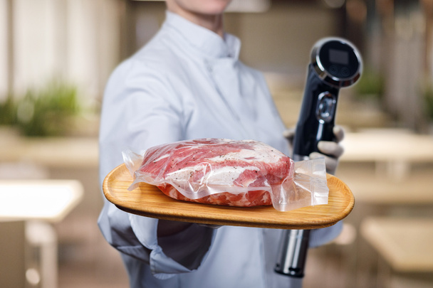 Shows cook sous vide immersion circulator cooker and the meat . - Photo, Image
