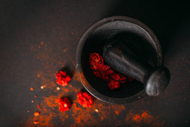 Red spicy dry carolina reaper. Dark food photography. Copy space. - Photo, Image