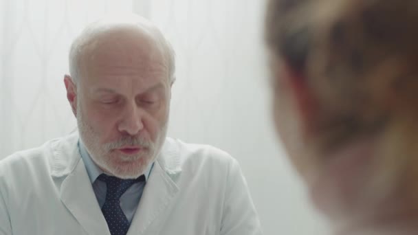 Professional doctor giving a prescription medicine to a young patient - Felvétel, videó