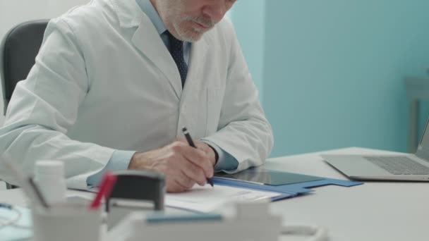 Doctor giving a prescription to a patient - Video, Çekim