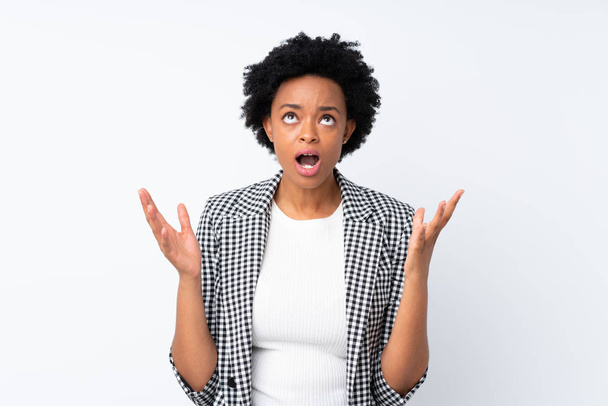 African american woman with blazer over isolated white background frustrated by a bad situation - Photo, Image