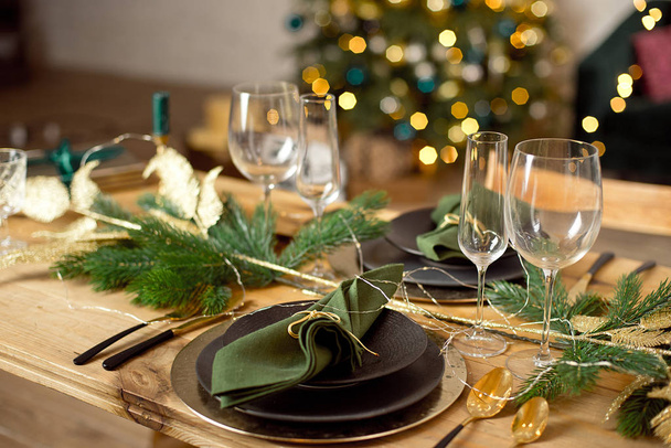 Table served for Christmas dinner in living room, close-up view, table setting, Christmas decoration. - Фото, изображение