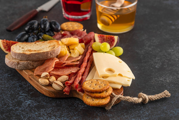 Italian food ingredients ham, salami, parmesan, olives, honey, bread. - Valokuva, kuva