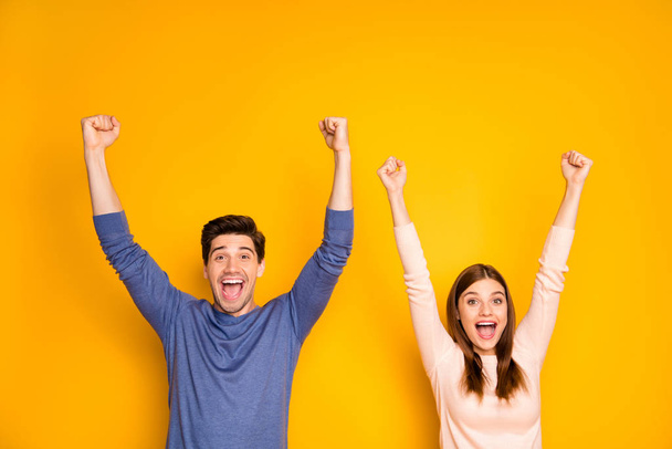 Portrait of funky ecstatic married couple feel rejoice emotion win lottery impressed scream wow omg raise fists wear stylish outfit isolated over bright color background - Fotografie, Obrázek