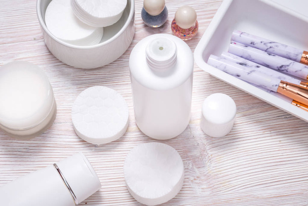 Set of plastic bottles for cream or face lotion on wooden table - 写真・画像