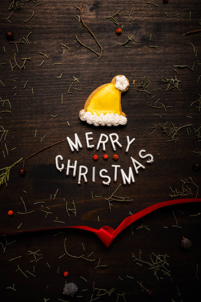 Merry Christmas text with gingerbread Santa Claus hat - Φωτογραφία, εικόνα