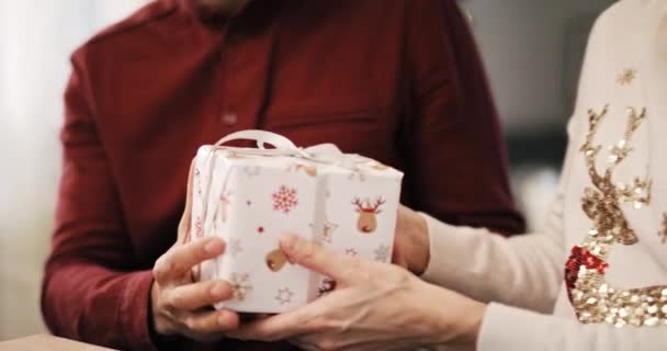 Handheld view of man giving Christmas gift  - Záběry, video