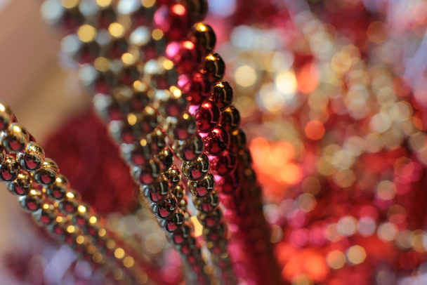 New Years shiny flickering beads,christmas vibrant decor details macro photo bokeh lights - Foto, Bild