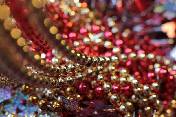shining Christmas shiny toy and bright beads decorate the New Year spruce macro view - Фото, изображение