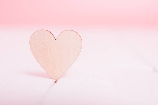 Wood heart on white wooden have pink background, valentine day concept - Photo, image