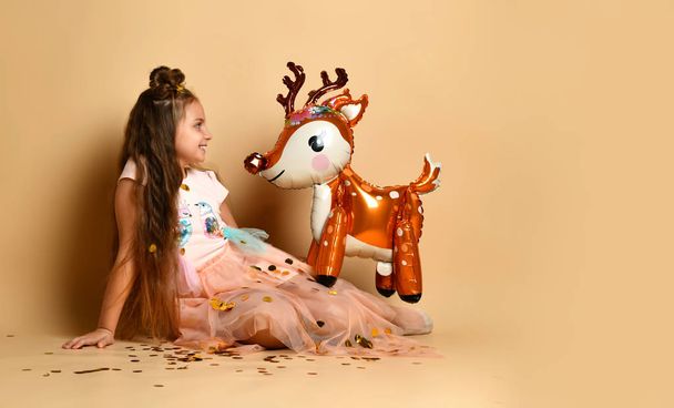 Cute girl with a deer in the studio - Photo, Image
