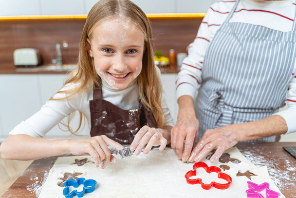 Cute young Caucasian girl making homemade cookies - Foto, Imagen