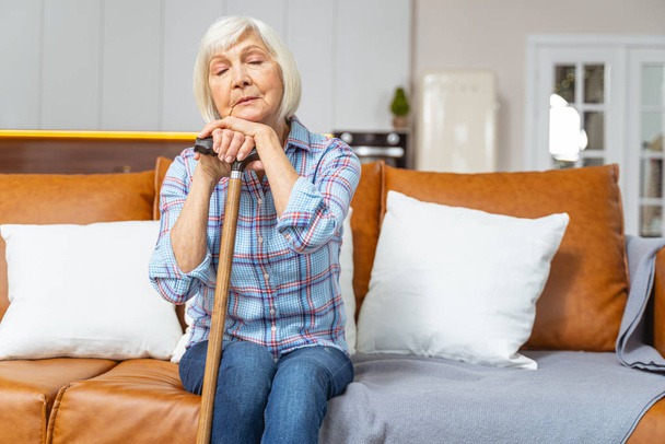 Senior lady sleeping with a walking stick - Фото, изображение