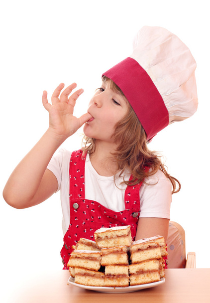 маленька дівчинка готує лиже цукор з пальця
 - Фото, зображення