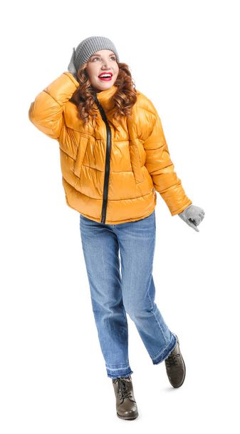Happy young woman in winter clothes on white background - Foto, imagen