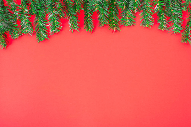 Happy New Year and Christmas day, top view flat lay composition decoration tree fir on red background with copy space for your text - Photo, Image