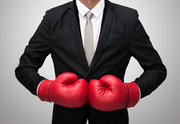 Businessman standing posture in boxing gloves isolated on over gray background - Fotó, kép