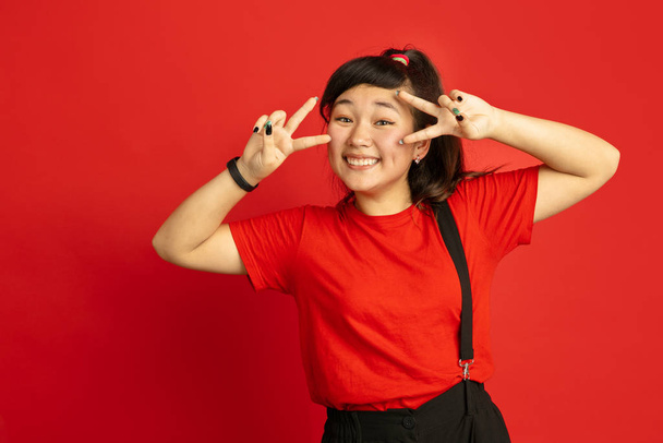 Asian teenagers portrait isolated on red studio background - Foto, Bild